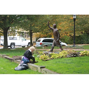 Woman works beneath statue in Hopkinton