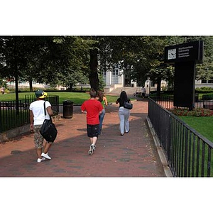 Four students walk through Krentzman Quadrangle during the Torch Scholars Scavenger Hunt