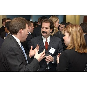 Three people converse at The National Council Dinner