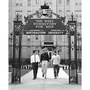 Three students exit West Dormitory for Men