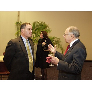 Joseph Malarny (CBA '82), left, conversing at the College Business Administration's Distinguished Service Awards ceremony