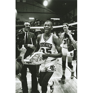 Reggie Lewis smiles as he heads toward the basket to celebrate the Huskies 3rd straight ELAC Championship