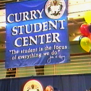 A banner with a President Curry quote hanging over the stage at the Curry Student Center dedication
