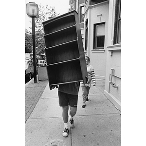 Student moving bookcase on Move-In Day