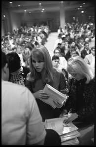 Young women distributing tests at the Selective Service College Qualification examination to determine eligibility for an educational deferment from service in the Vietnam War