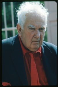 Alexander Calder: three-quarter profile bust portrait in a red tie