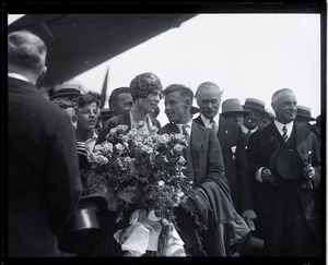 Amelia Earhart reception: Earhart with bouquet of flowers and Wilmer Stultz (pilot), Mayor Edward H. Larkin of Medford, and Gov. Alvan T. Fuller (l. to r.)