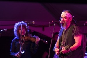 Steve Earle (guitar) and Eleanor Whitmore (fiddle) performing onstage with Steve Earle and the Dukes at the Payomet Performing Arts Center