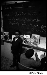 Young boy at the blackboard beneath the sogan 'Soul is a feeling, anybody can have it': Liberation School, Boston, Mass.