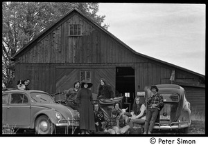Commune members gathered around their vehicles outside the barn, Packer Corners commune