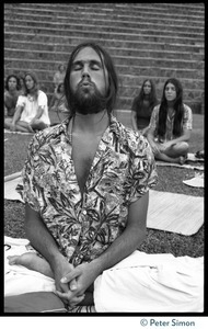 Man in deep meditation during Ram Dass's appearance at Andrews Amphitheater, University of Hawaii