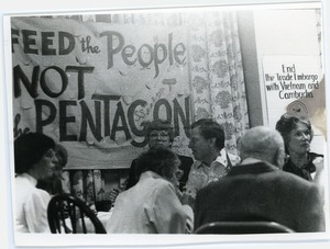 Nuclear Freeze rally at the Edwards Church: attendees seated under a banner reading 'Feed the people, not the Pentagon' and sign reading 'End the trade embargo with Vietnam and Cambodia'