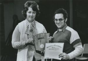 Two unidentified physical plant staff holding awards