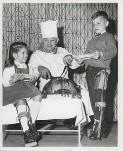 Chef carving turkey for young clients at Thanksgiving dinner