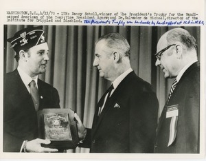Danny Scholl is awarded the 1969 president's trophy by Vice President Spiro Agnew and Dr. Salvador de Michael
