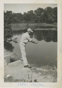 Unidentified man fishing in a pond