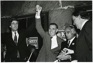 Mayor Raymond L. Flynn holding hands high with John Kerry, Francis X. Bellotti and an unidentified man