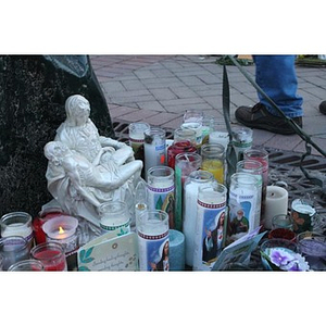 Religious statue and candles at Boston Marathon memorial