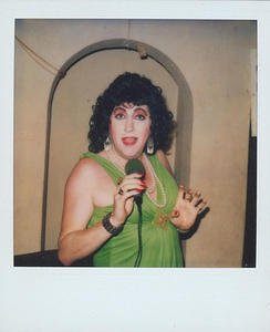 A Photograph of Billie Loba Singing Wearing a Green Dress