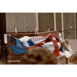 Two men unfurl a giant Puerto Rican flag