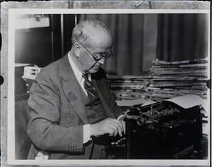 Arthur Brisbane, seated at a typewriter