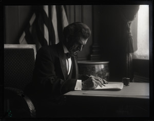 Lincoln Caswell, Abraham Lincoln impersonator, writing at a desk