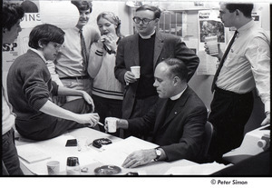 Malcolm Boyd at Boston University: Boyd (seated) in the BU News room with (l-r) Richard Schweid, Raymond Mungo, Joe Pilati, an unidentified woman, and two unidentified men