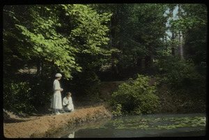 George W. Cable Garden (two women looking into pond with water lilies, trees in background)