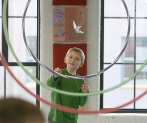 Jacob Sullivan, 6, launches a paper airplane through hula hoops, Providence Children's Museum