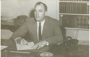 John Gillespie sitting in office, behind desk