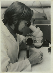 Henry Howard Hagedorn looking into a microscope