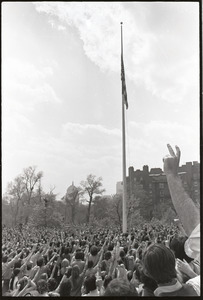 Demonstration at State House against the killings at Kent State: protesters raising fists at lowering of American flag on Boston Common