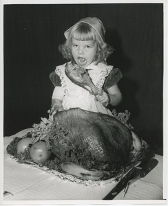 Little girl with turkey leg