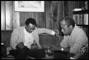James Baldwin (right) talking with David Graham Du Bois, at the book party for Robert H. Abel