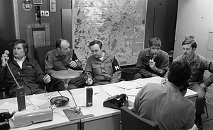 U.S. Army military policeman Gavigan and unidentified men in Boston Police Dispatch Operations Center conference room