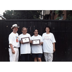 David Cortiella and Carmen Cotto (?) stand with runner up winners in the dominoes competition at Festival Betances.