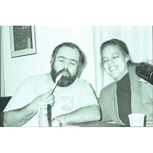 Efrain Collado and unidentified female staffer mug for the camera during a staff meal.