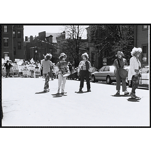 Hills Mills Clown Band standing on a street during the Boys and Girls Clubs of Boston 100th Anniversary Celebration Parade