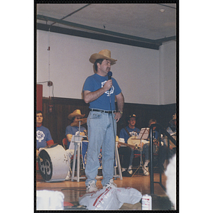 A Bunker Hillbilly alumnus speaks into a microphone at a reunion event