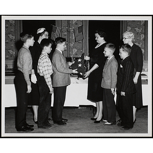 Youth receiving the American flag at a Marters Club event