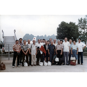 Association members pose outdoors at an airport in China
