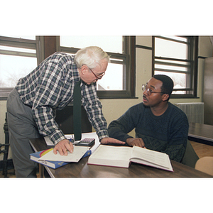 Northeastern University math professor Bob Case speaks with a mentor in a calculus class at Hyde Park High School