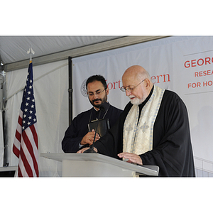 Two Greek Orthodox priests lead a prayer during the groundbreaking ceremony