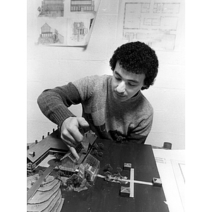 Student building an architectural model