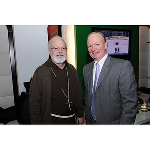 Cardinal O'Malley posing with a guest at the Beanpot Reception