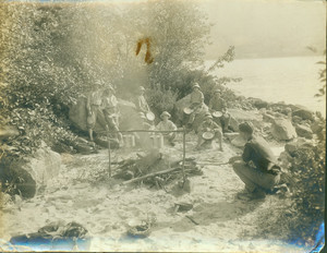 Campers around a campfire, location unknown, undated
