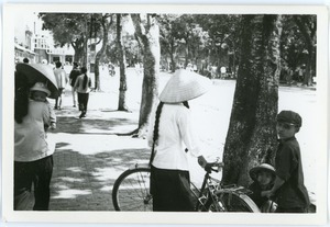 Street scene near Hoan Kiem Lake, with family in foreground