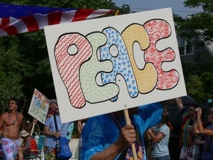 Parade marcher with sign reading 'Peace' : Provincetown Carnival parade