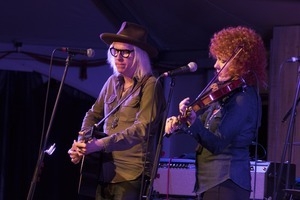 Chris Masterson (guitar) and Eleanor Whitmore (fiddle) performing onstage with Steve Earle and the Dukes at the Payomet Performing Arts Center