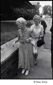 Two elderly women walking on a sidewalk - Digital Commonwealth